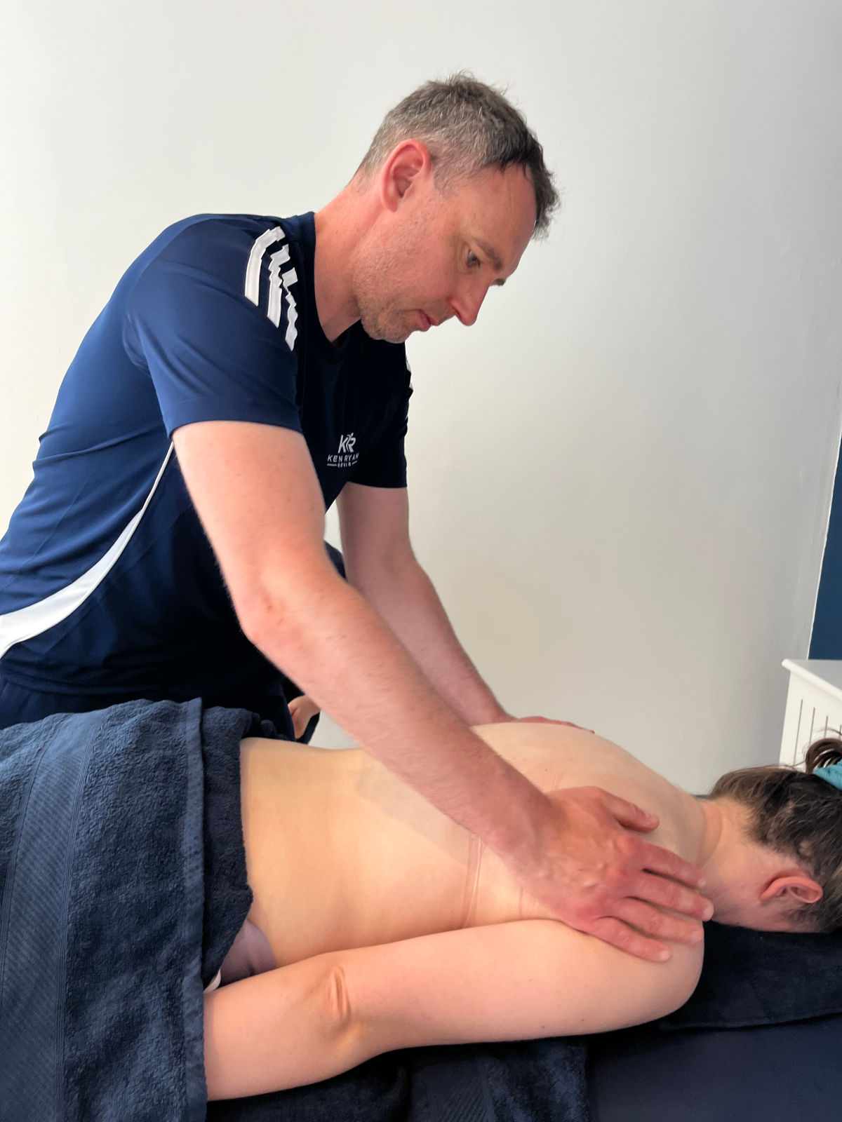 Ken treating a client's upper back